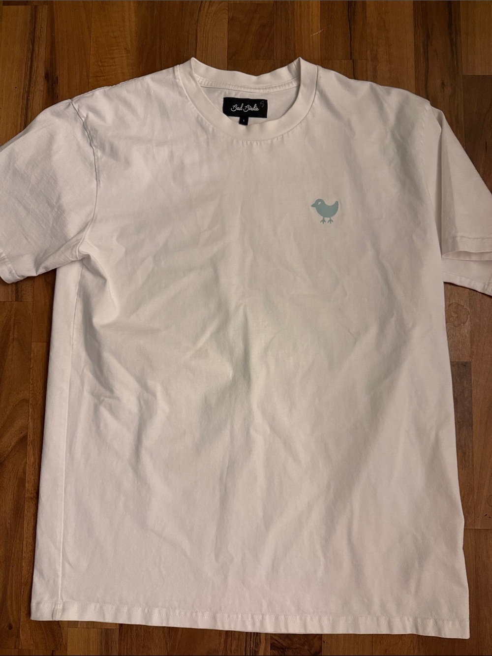 Bad Birdie White Tee with Pale Blue Bird Logo